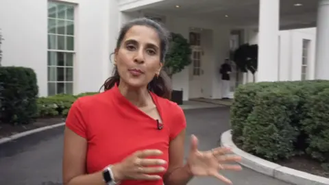 BBC's Nomia Iqbal in a red top outside the White House