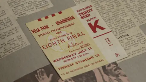 A photo of a ticket up close. It's a yellow ticket with red writing for the world cup Eighth final