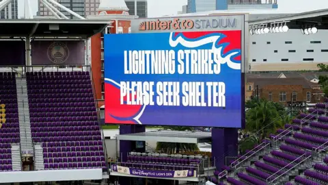 Big screen saying 'lightning strikes please seek shelter'