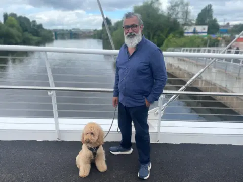 Man with dog on bridge