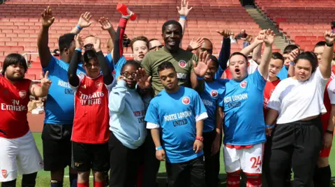 Krome 21 CIC Founder and coach Harold Bennett on the pitch with some of the North London United players