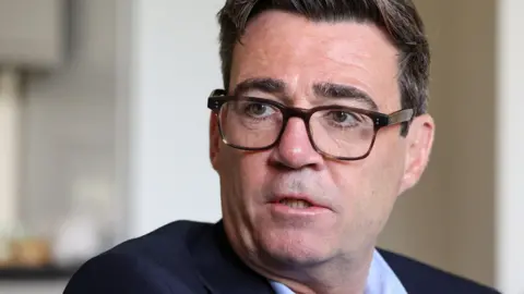 Reuters Prime Minister Andy Burnham, a middle-aged man with short hair and glasses who is wearing a navy suit, during a visit to Newcastle - his expression of concerned.