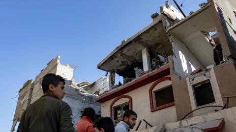 Palestinians inspect damages of their home after an Israeli airstrike targeted the Rafah refugee camp, southern Gaza 