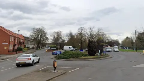 Google Cars and vans drive around a roundabout in York