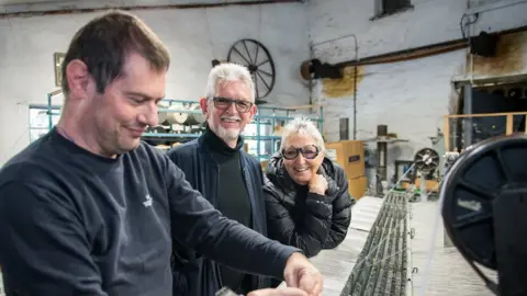 ROB MELEN  staff member alongside Eifion and Amanda Griffiths