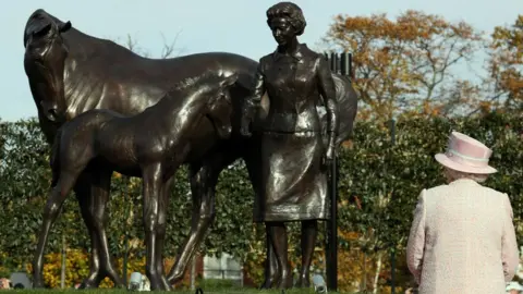 PA Media Queen Elizabeth II at Newmarket Racecourse, after she unveiled a statue of herself with a foal and a mare as a gift in the year of her 90th birthday, during a visit to the town often referred to as the headquarters of British racing