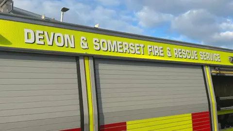 A close up of a fire engine which says Devon and Summerset Fire and Rescue Service