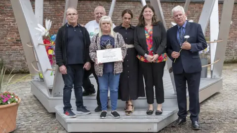 Jason Roberts (left to right) Mike and Marie Causer (front, Michael's parents), Steve Mcfarlane (outgoing chair of trustees, Michael Causer Foundation), Racheal Jones (CEO One Knowsley), Emily Spurrell, Graham Morgan