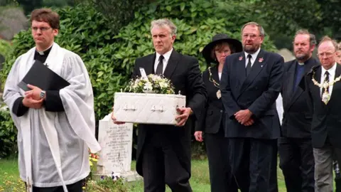 Liverpool Daily Post/PA Funeral procession held for the baby showing a priest leading the infant carried in a white coffin by a man in a black suit with other mourners following