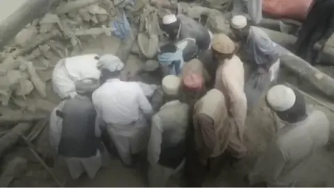 People gathering to rescue someone from rubble