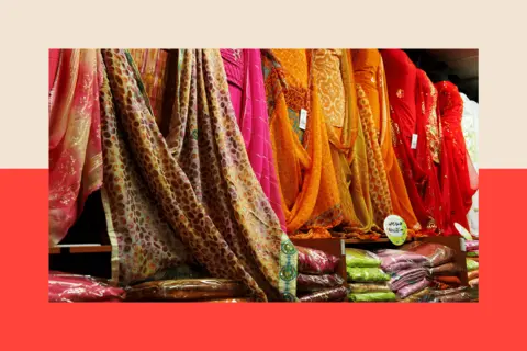 Getty Images A row of traditional South Asian dresses in a store