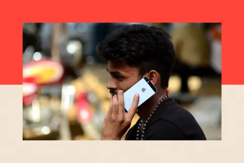 NurPhoto via Getty Images An man talks on his iPhone 

