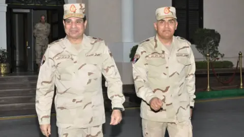 Reuters Egyptian military chief Field Marshal Abdul Fattah al-Sisi (L) walks with Gen Sidqi Sobhi (R) after meeting of the Supreme Council of the Armed Forces, in Cairo (26 March 2014)