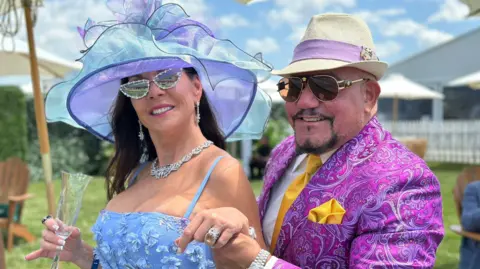 BBC/Brandon Drenon Two people pose for a photo on the infield at Pimlico