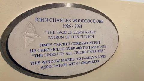A plaque honoring John Woodcock in St Nicholas Church in Longparish.
