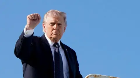 US President Donald Trump pumps his fist