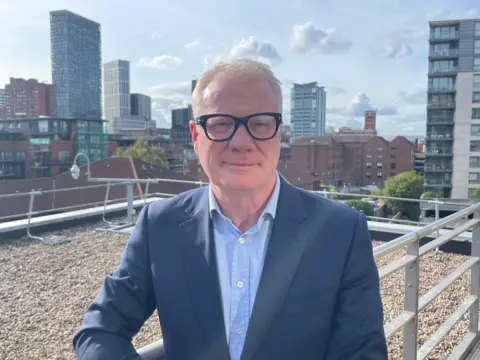 Mayor standing on balcony overlooking Birmingham city centre