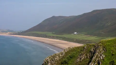 Getty Images A general view of Rhossili Bay beach on the Gower in Rhossili, Wales. 