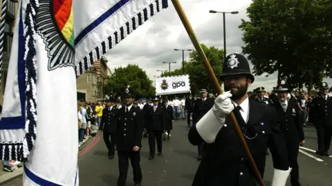 Getty Images Gay police officers marching in uniform at Gay Pride 2003