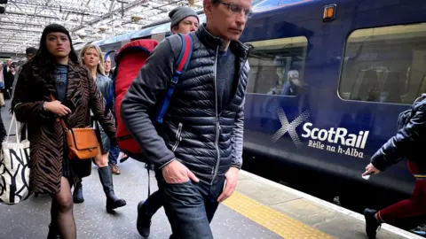 PA Media scotrail train and commuters