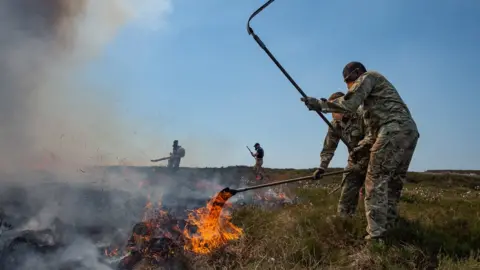 EPA Soldier working on fire on Saddleworth Moor