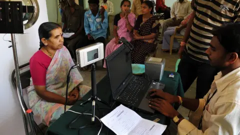 Getty Images An Indian villager looks at an Iris scanner during the data collecting process for Aadhaar.
