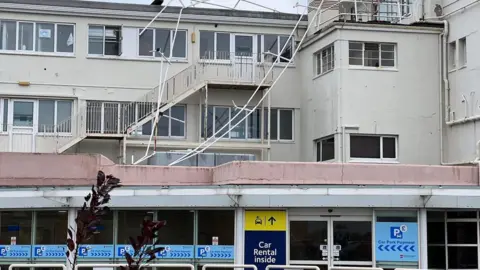 Railings hanging off the airport building