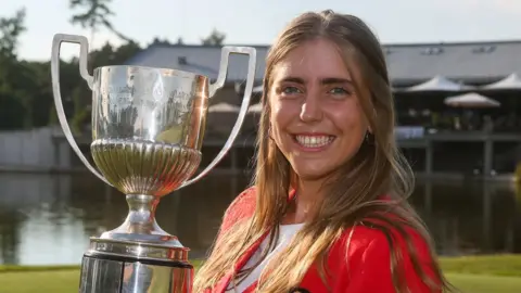 EGA Arozamena is pictured holding the European Ladies' Amateur Championship trophy