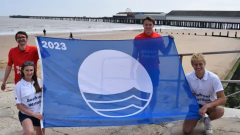 Tendring District Council Staff at Walton-on-the-Naze beach with the Blue Flag