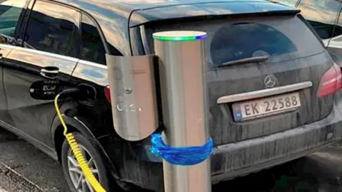 an electric Mercedes car being charged at a recharging station in Oslo, on 1 January 2019.