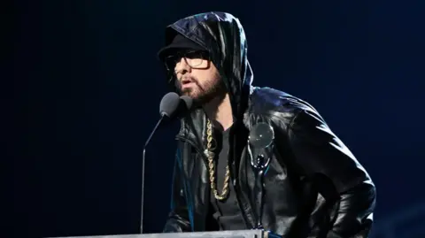 Getty Images Eminem onstage during the 37th Annual Rock & Roll Hall of Fame in 2022