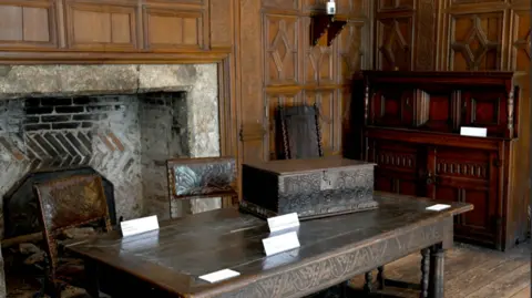 Leicester City Council Wooden panelling, table and large fireplace 