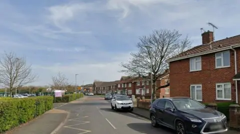 Google Maps image of Talbot Street. It has several red brick houses with cars parked alongside.