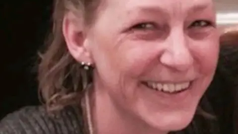 Metropolitan Police Dawn Sturgess, pictured smiling at the camera. The picture is cropped very close, though she can be seen wearing a grey sweater and stud earrings. She has short, dark blonde hair. 