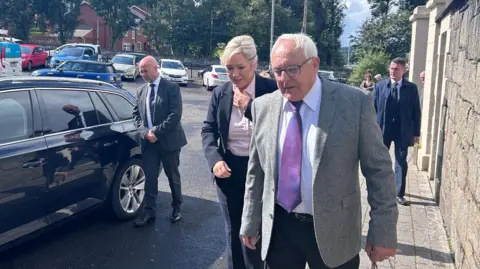 First Minister Michelle O'Neill enters the church in Derry for the funeral of Nell McCafferty