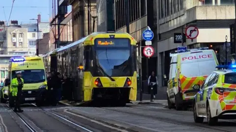 BBC Tram flanked by ambulance and police vehicles at the collision scene