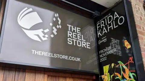 Sign for the Reel Store