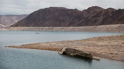 A World War II-era Higgins landing craft rests on the exposed shoreline at Lake Mead National Recreation Area