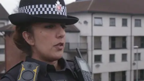 Inspector Meena Yasin on the balcony of one of the flats on the Freehold estate