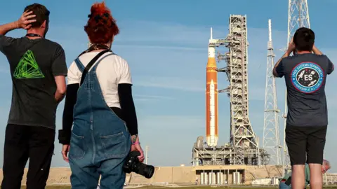 People taking photographs of the rocket