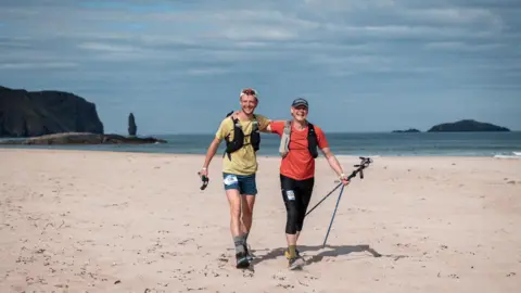 No Limits Photography Will Robinson alongside his father Tim Robinson on a beach