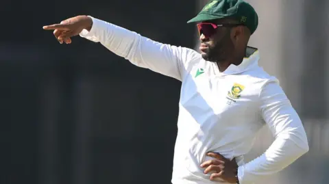 AFP via Getty Images South Africa's captain Temba Bavuma gestures during the fifth day of the second Test cricket match between India and South Africa at the Barsapara Cricket Stadium in Guwahati on November 26, 2025. (Photo by Biju BORO / AFP via Getty Images)