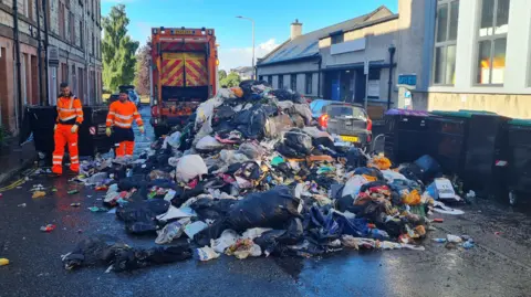 City of Edinburgh Council A residential street partially blocked by dumped rubbish.