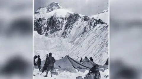 Durham University Special Collections George Mallory (seated), eating breakfast by Sherpa tents at Camp 2