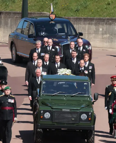 Reuters Queen Elizabeth in the Bentley State Limousine and members of the Royal Family follow the hearse during the funeral of Britain's Prince Philip, who died at the age of 99, on the grounds of Windsor Castle in Windsor, Britain, April 17, 2021.