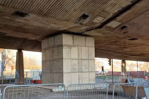 Large blocks of brick encase one of the flyover's pillars