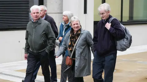 Eddie Mitchell Family members of victims arriving at the hearing in London