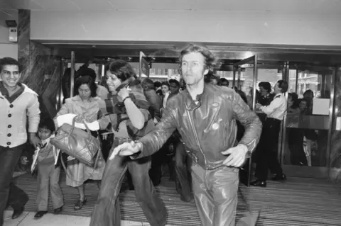 Getty Images Customers rush through the doors of Debenhams store