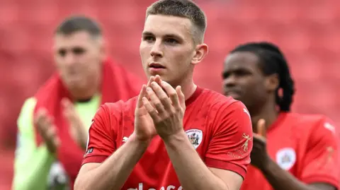 Jonathan Bland applauds the Barnsley fans
