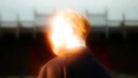 Group A.D. A blurry image of the back of a man's head.